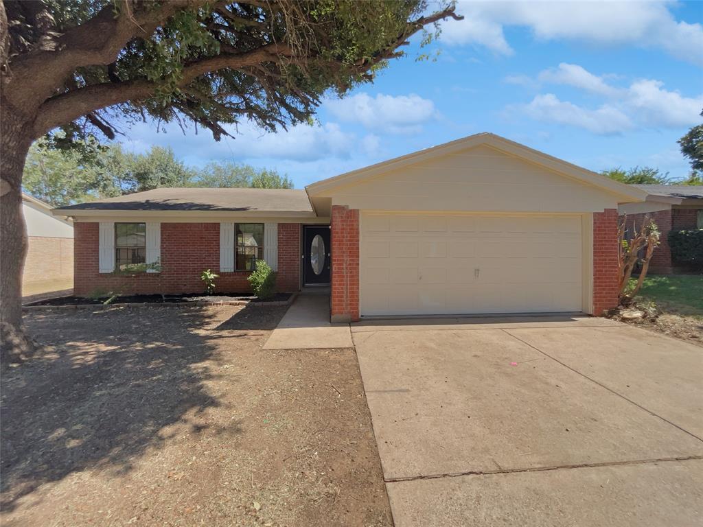 a view of house with backyard and parking