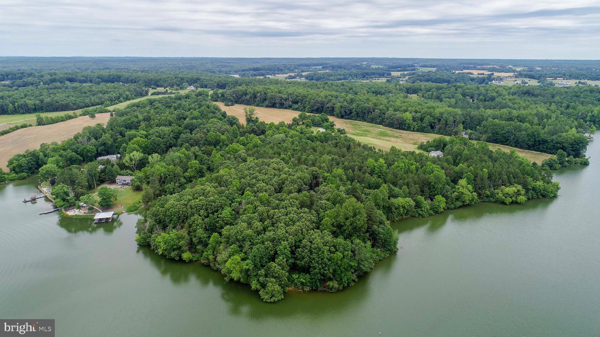 an aerial view of a house with a yard and lake view