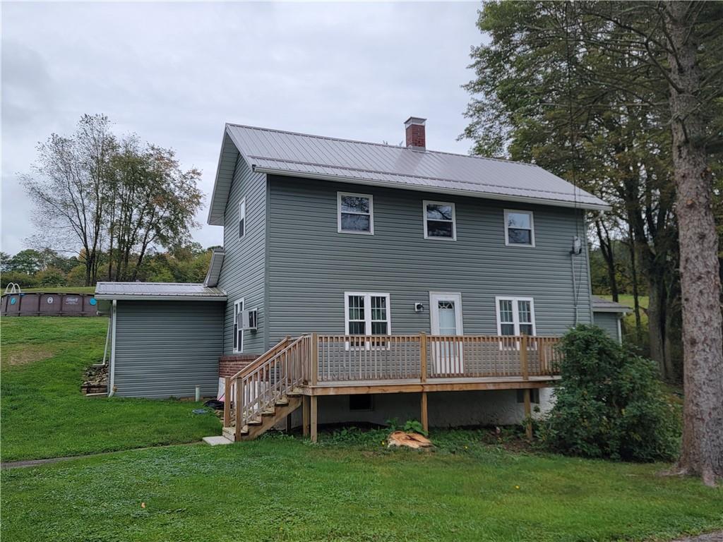 a front view of a house with a garden and deck