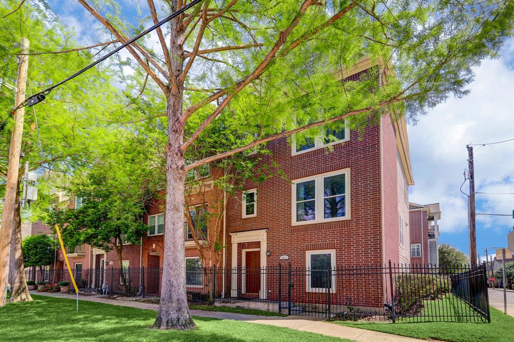 a view of a brick building next to a yard