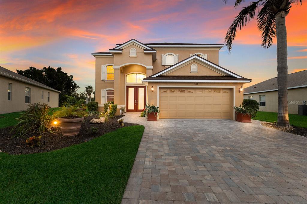 a front view of a house with a yard and garage