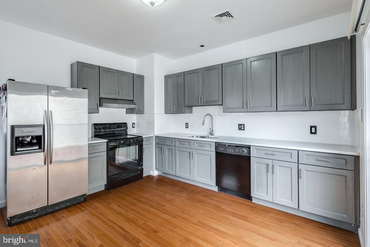 a kitchen with a sink cabinets and stainless steel appliances