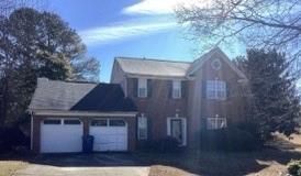 a front view of a house with yard