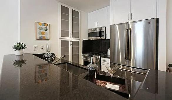 a view of a livingroom with furniture fridge and wooden floor