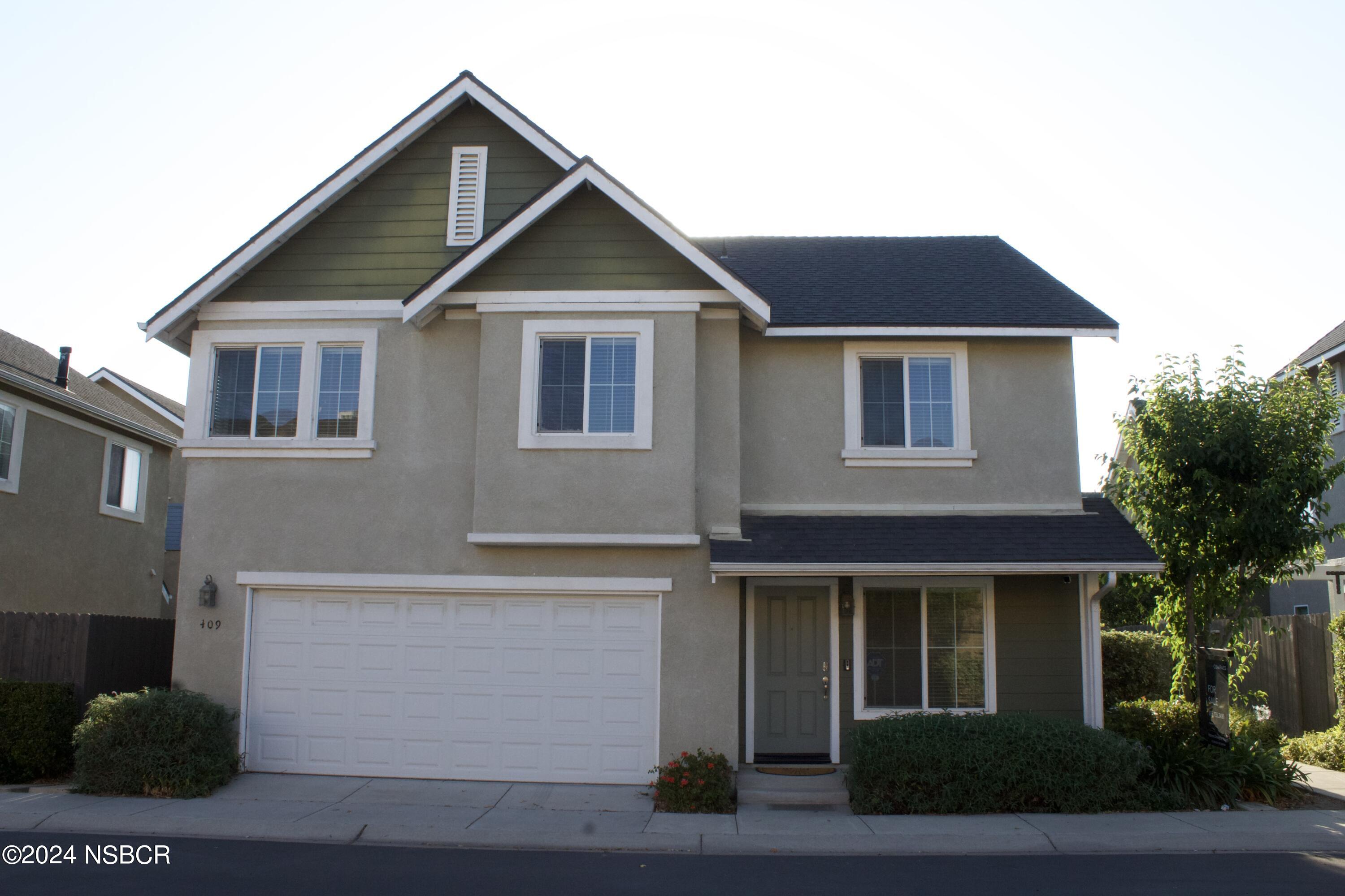 a front view of a house with garage