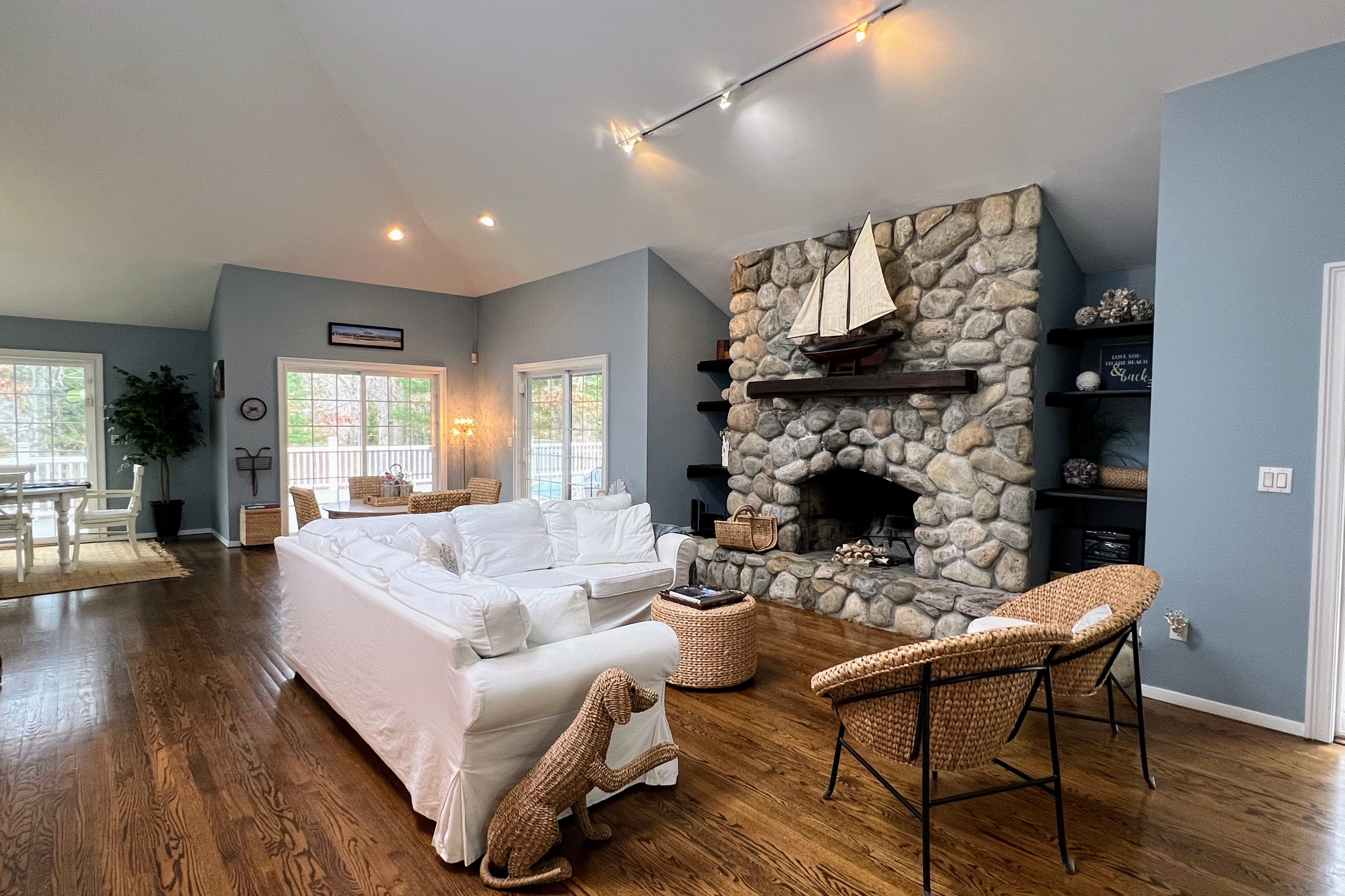 a living room with furniture a fireplace a rug and wooden floor