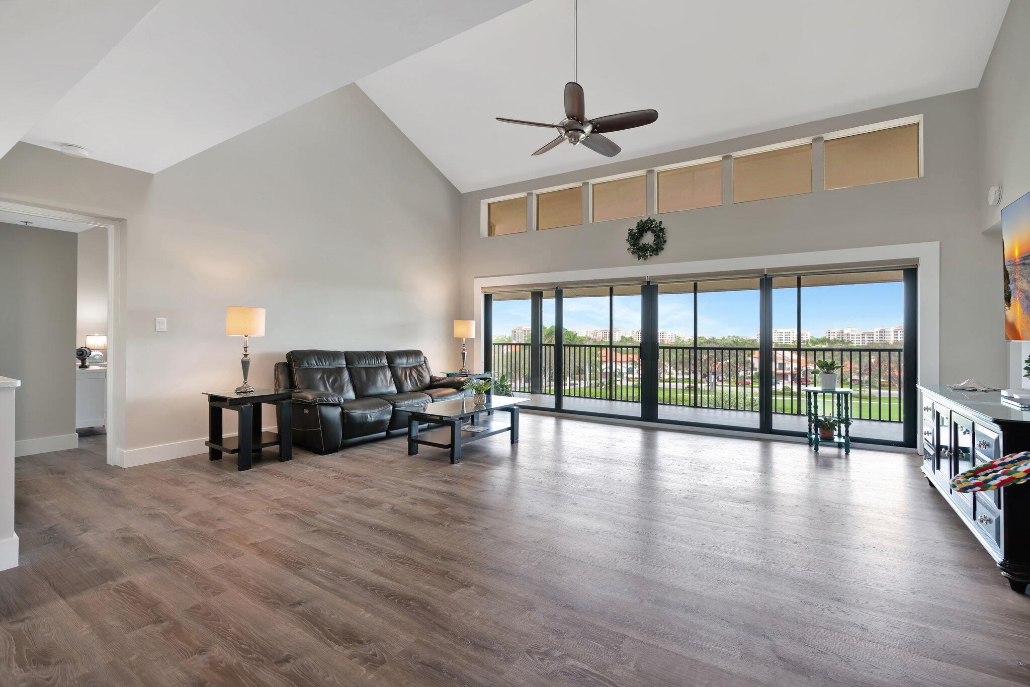 a living room with furniture and a floor to ceiling window