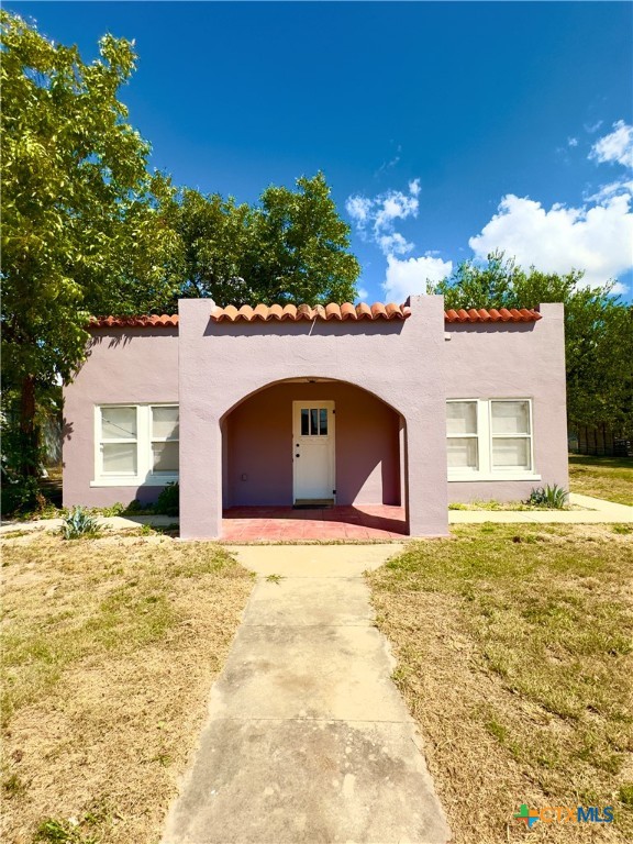 a house with yard and a large parking space