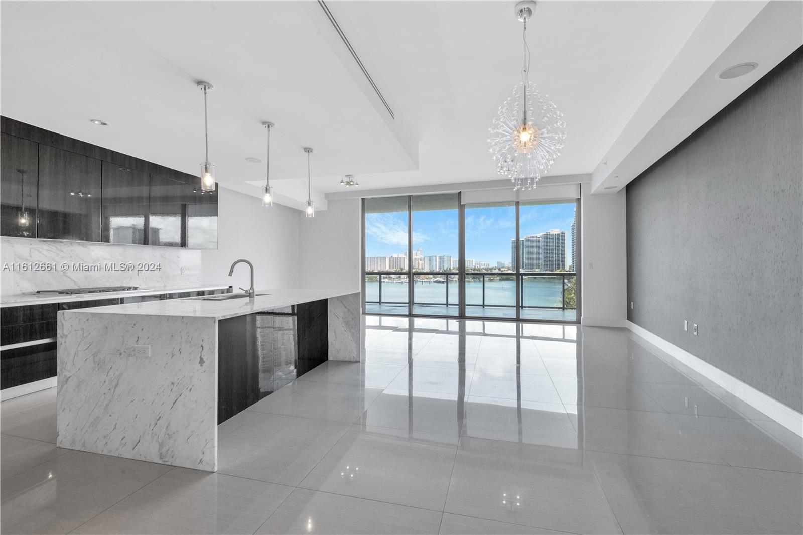 a large kitchen with kitchen island a large counter space a sink appliances and cabinets