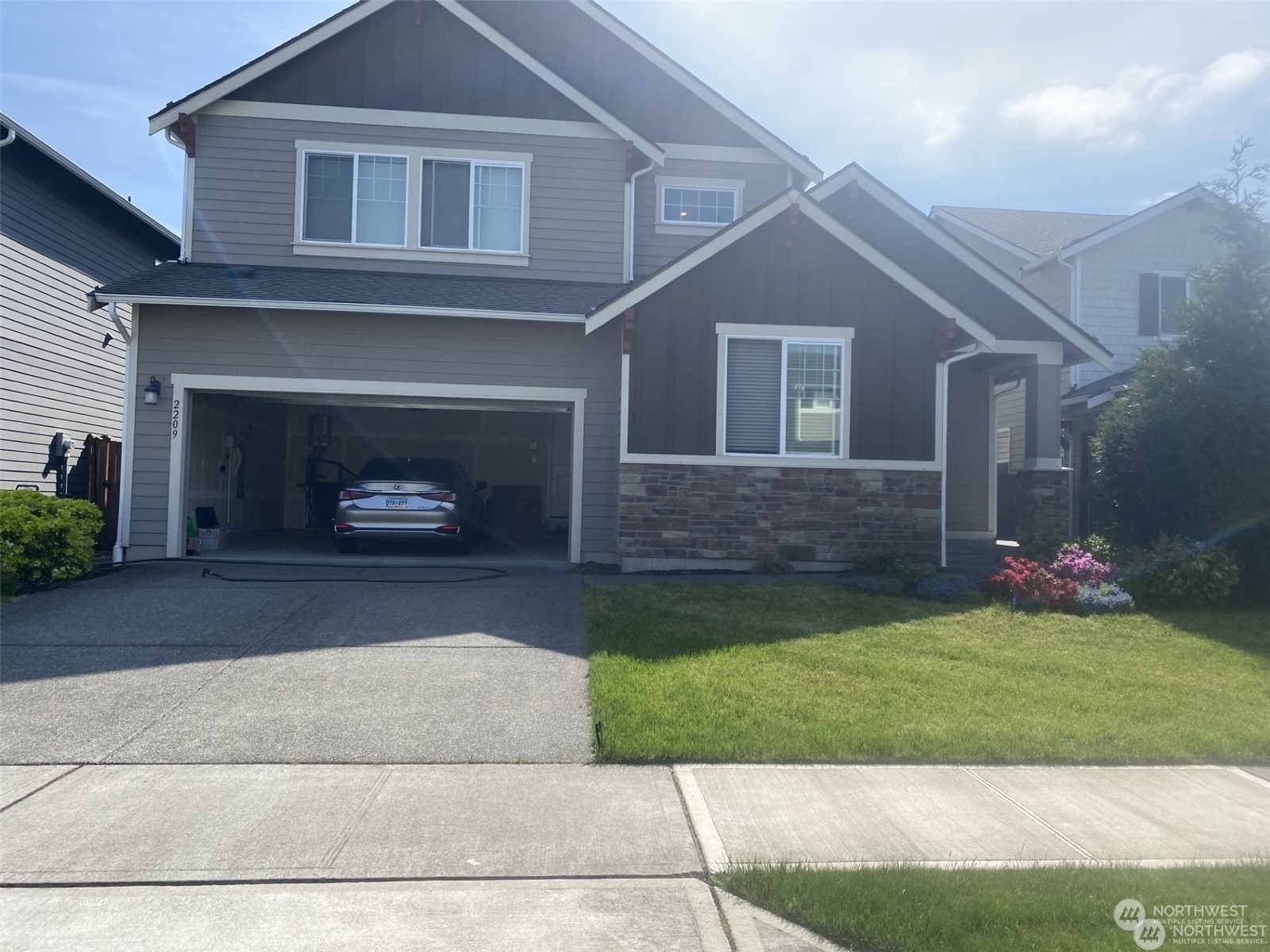 a front view of a house with a garden and yard