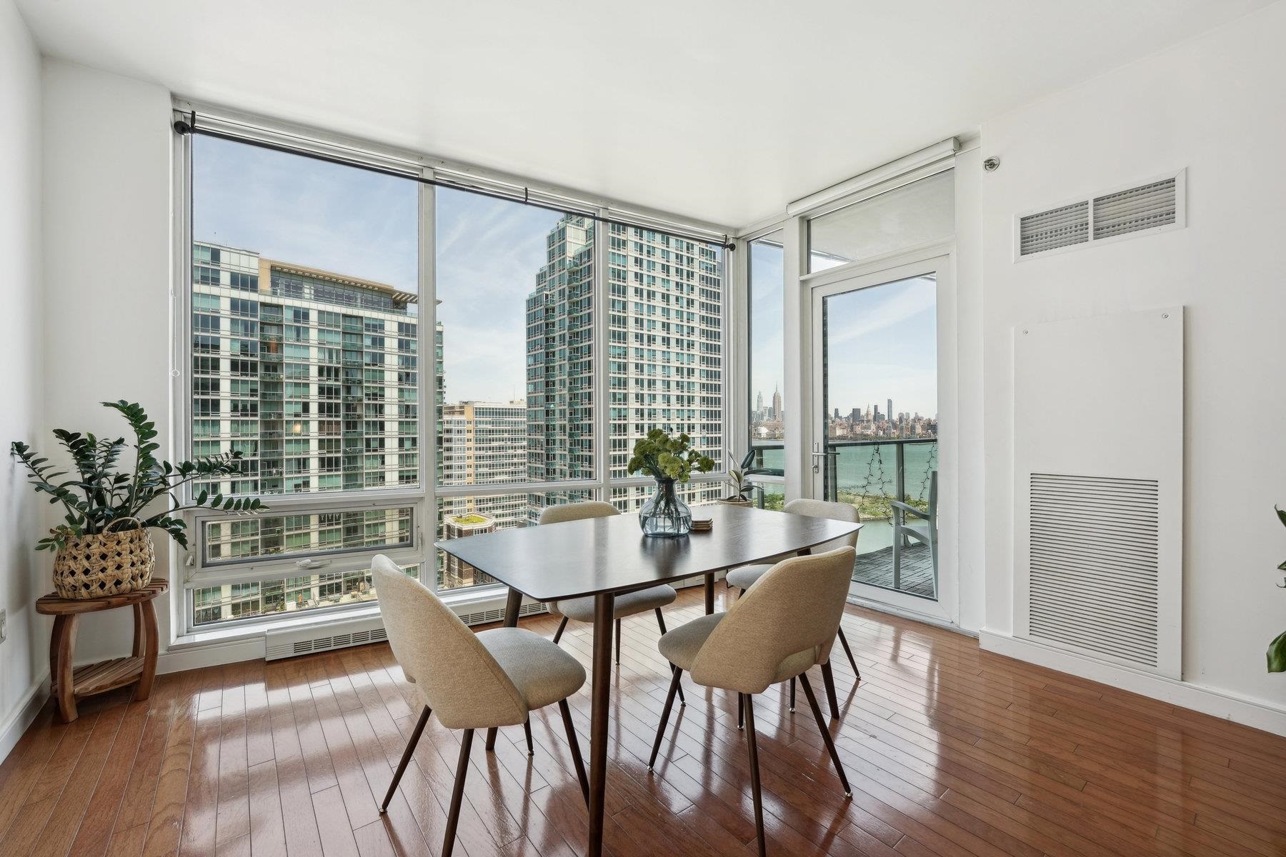 a dining room with furniture and wooden floor