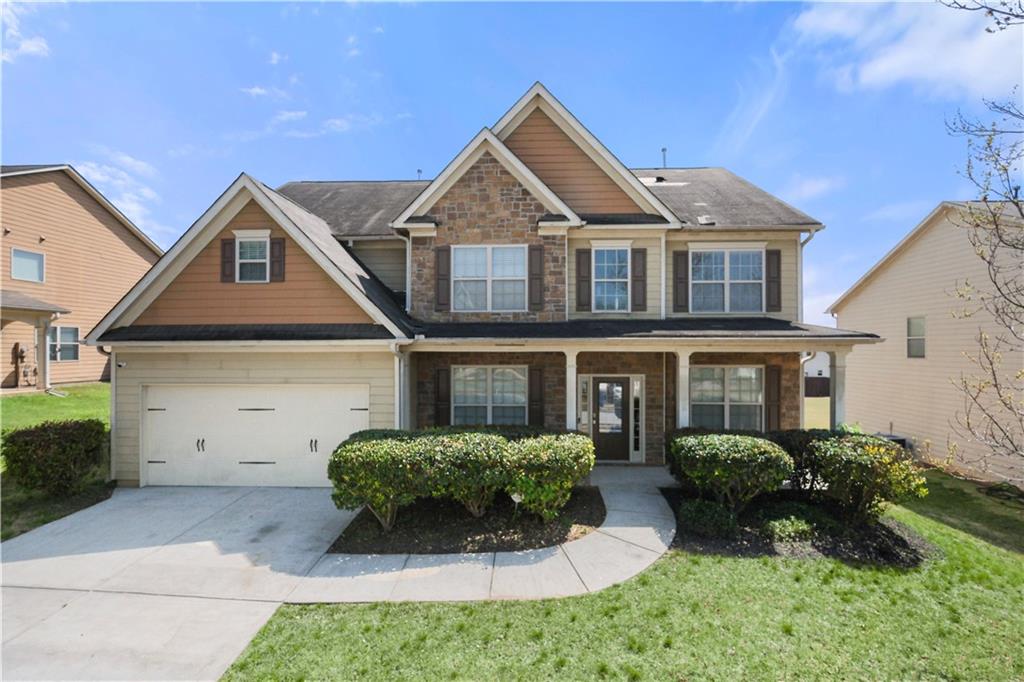 a front view of a house with a yard