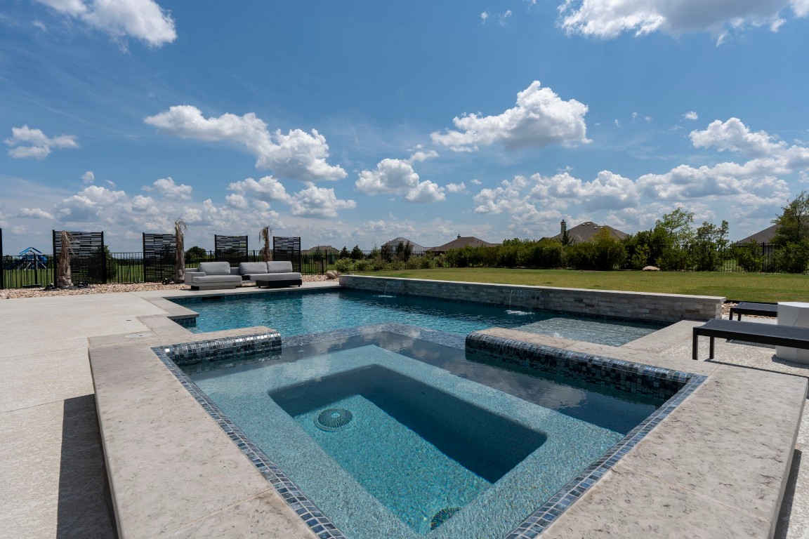 a view of a lake with couches in the patio