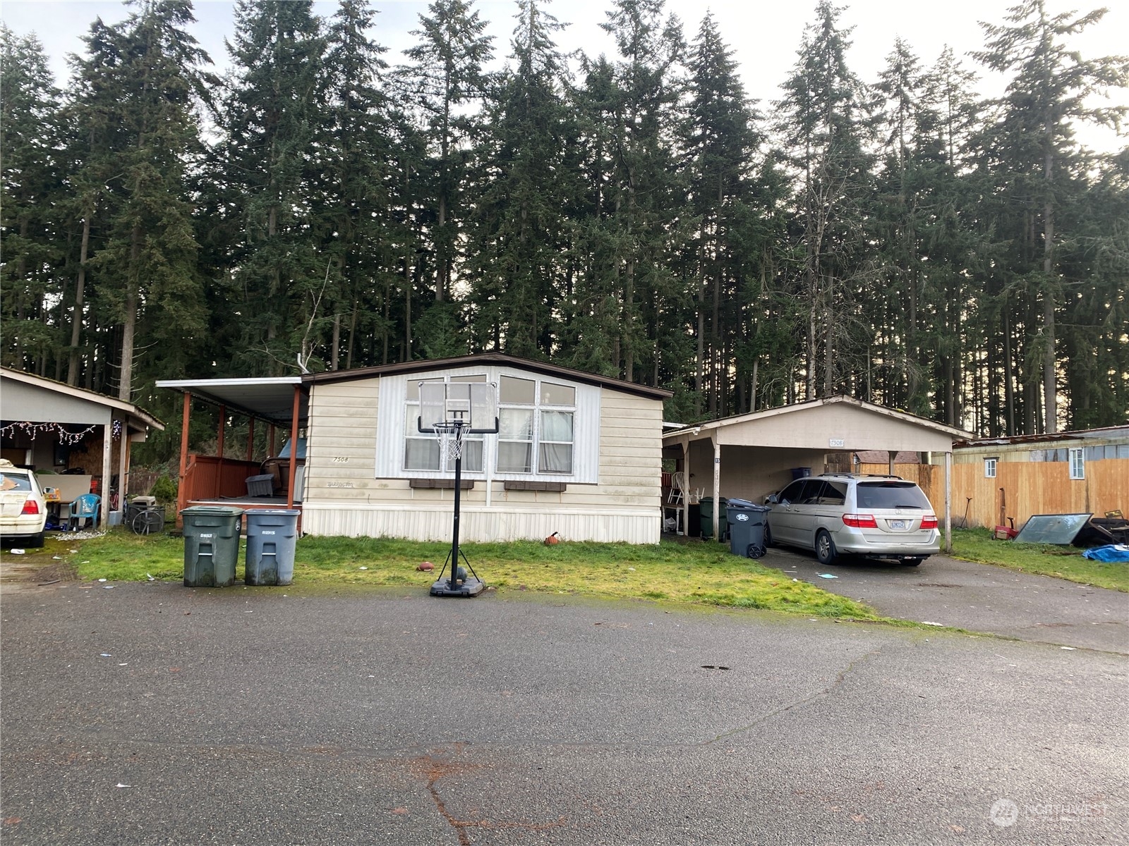 a car parked in front of a house with garage