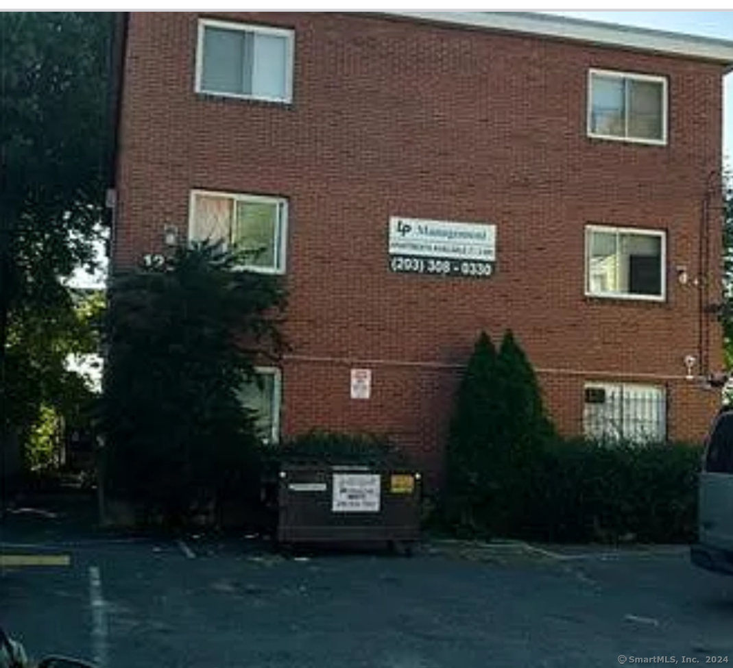 a view of a brick building next to a yard