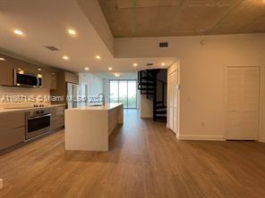 a view of a kitchen with furniture and a ceiling fan