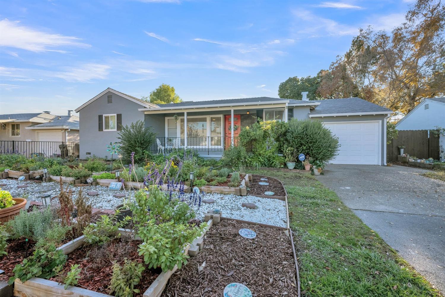 a front view of house with yard and trees around