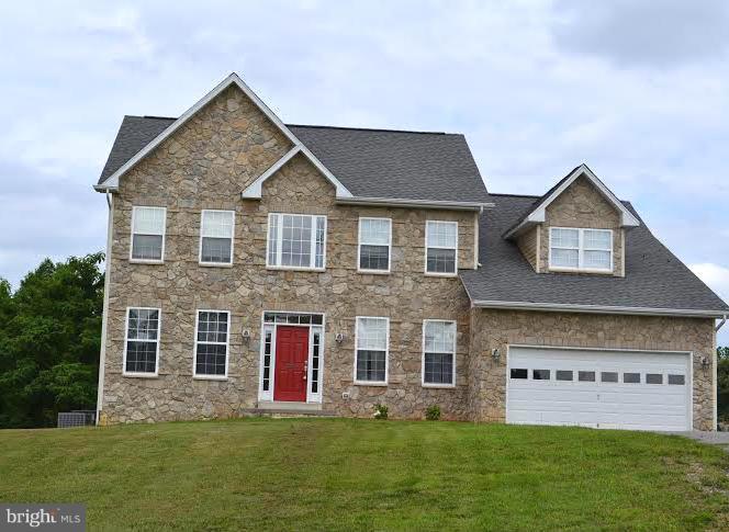 a front view of house with yard and green space