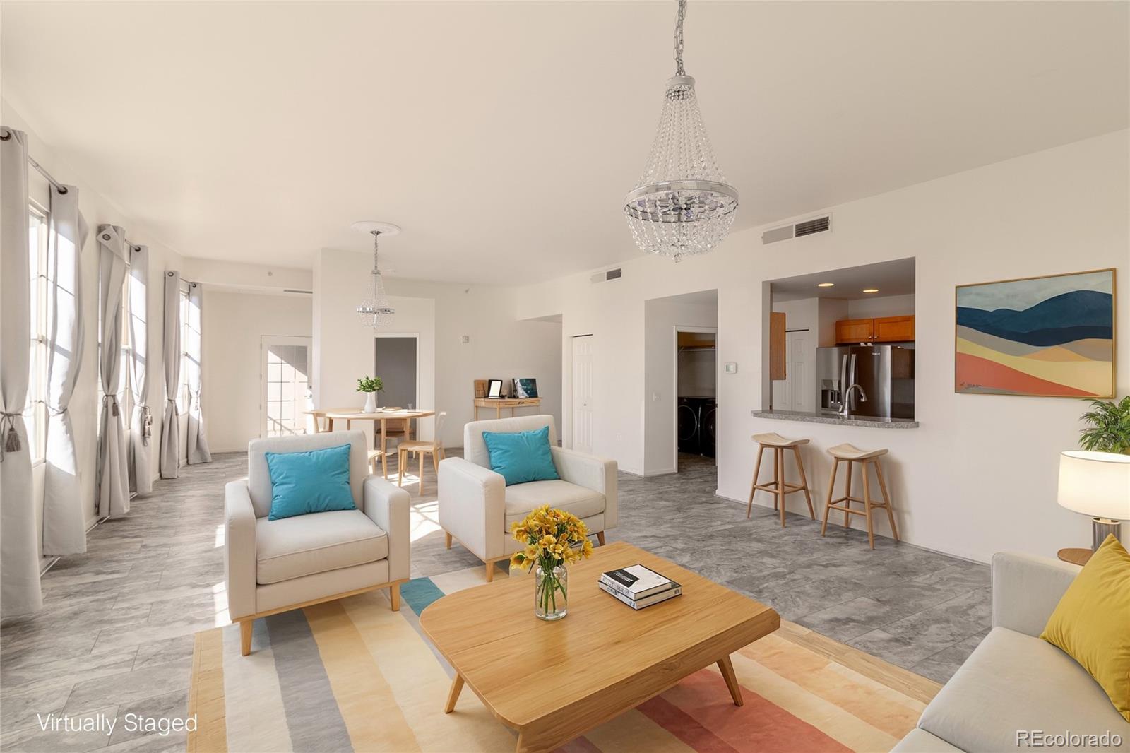 a living room with furniture and a chandelier