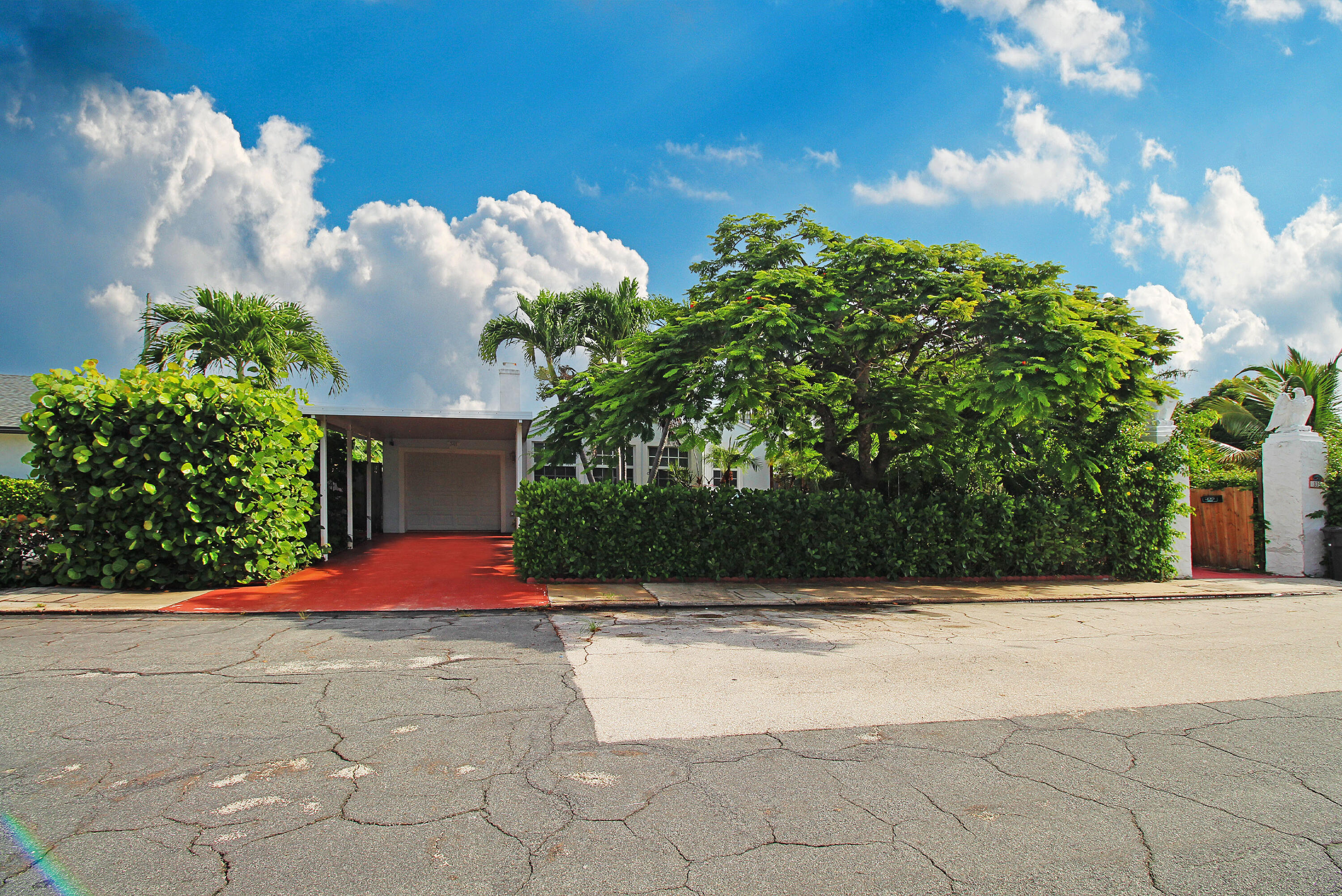 a front view of a house with a yard and trees