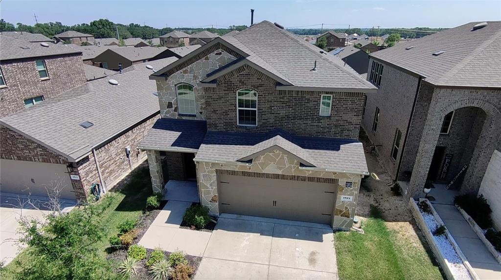 an aerial view of a house with a yard