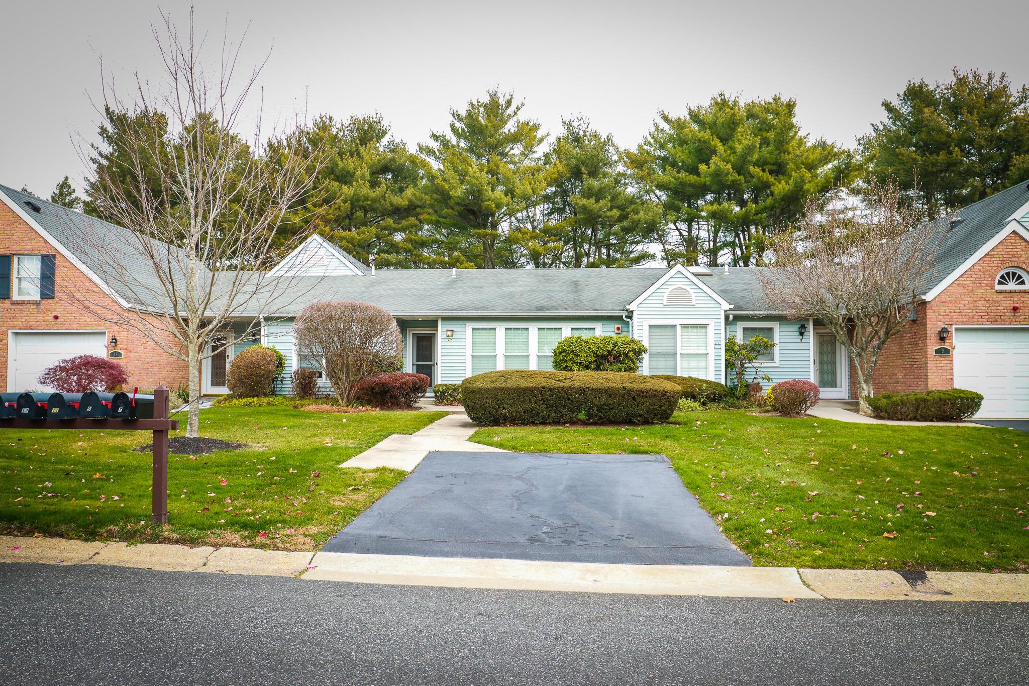 Ranch-style house with a front yard and a garage