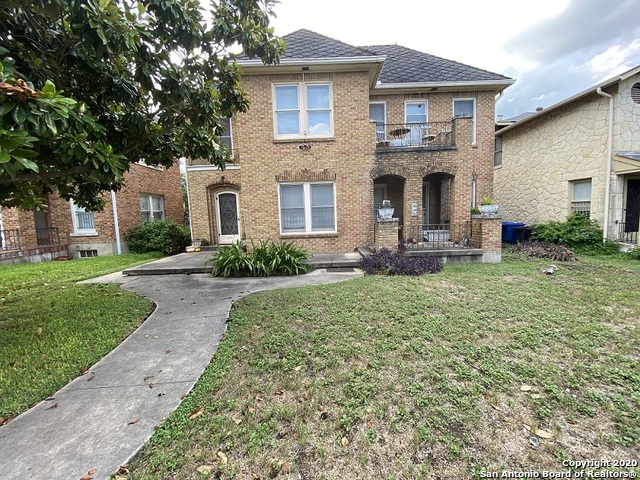 a front view of a house with garden and porch