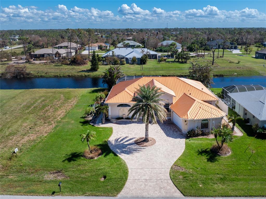 an aerial view of a house with outdoor space lake view and mountain view