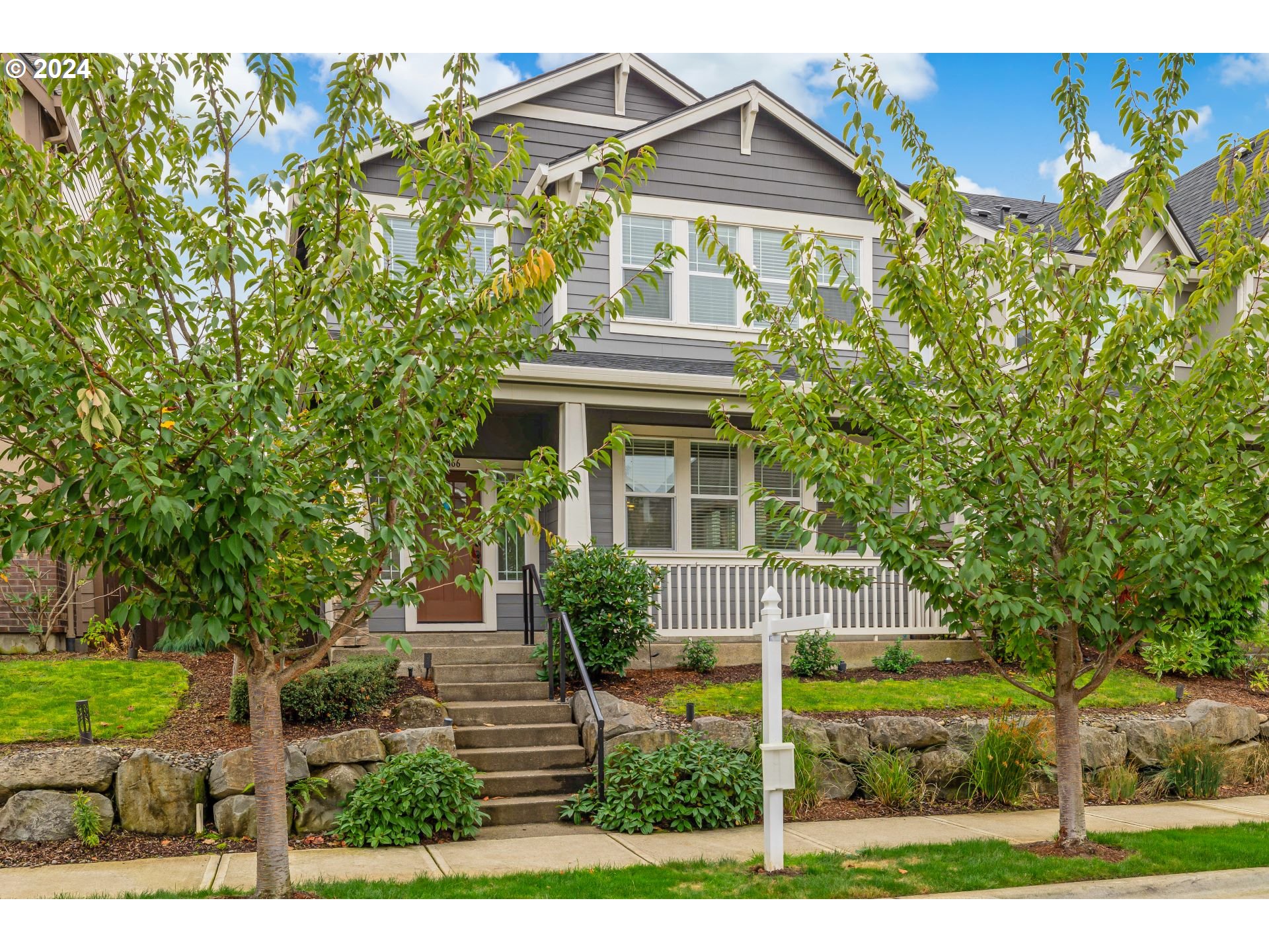 a front view of a house with a garden