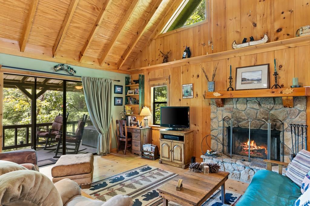 a living room with furniture a flat screen tv and a fireplace