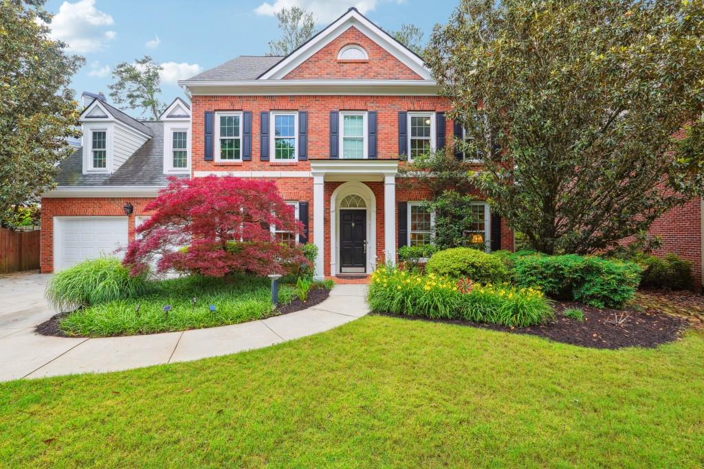 a front view of a house with a garden