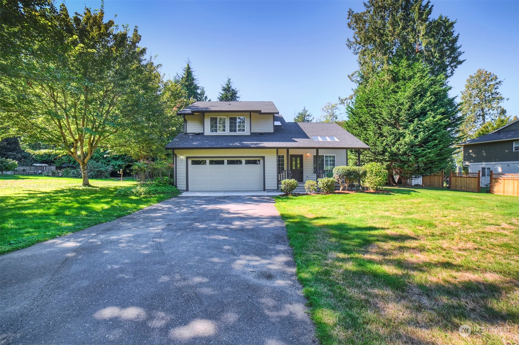 a front view of a house with yard and green space