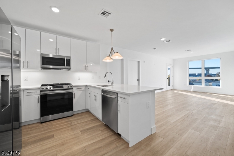 a kitchen with a stove and a kitchen view