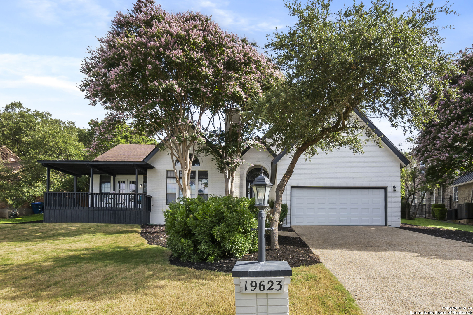 a front view of a house with a yard garage and outdoor seating