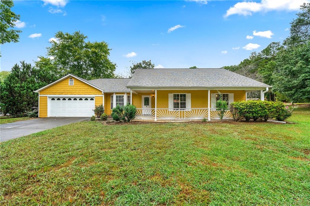 a view of a house with a yard and tree s