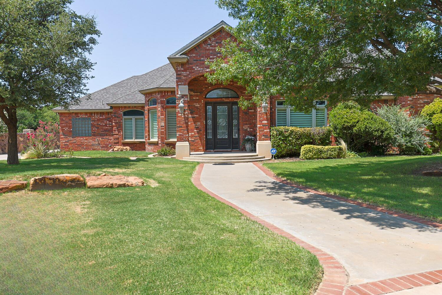 a view of a house with swimming pool and a yard