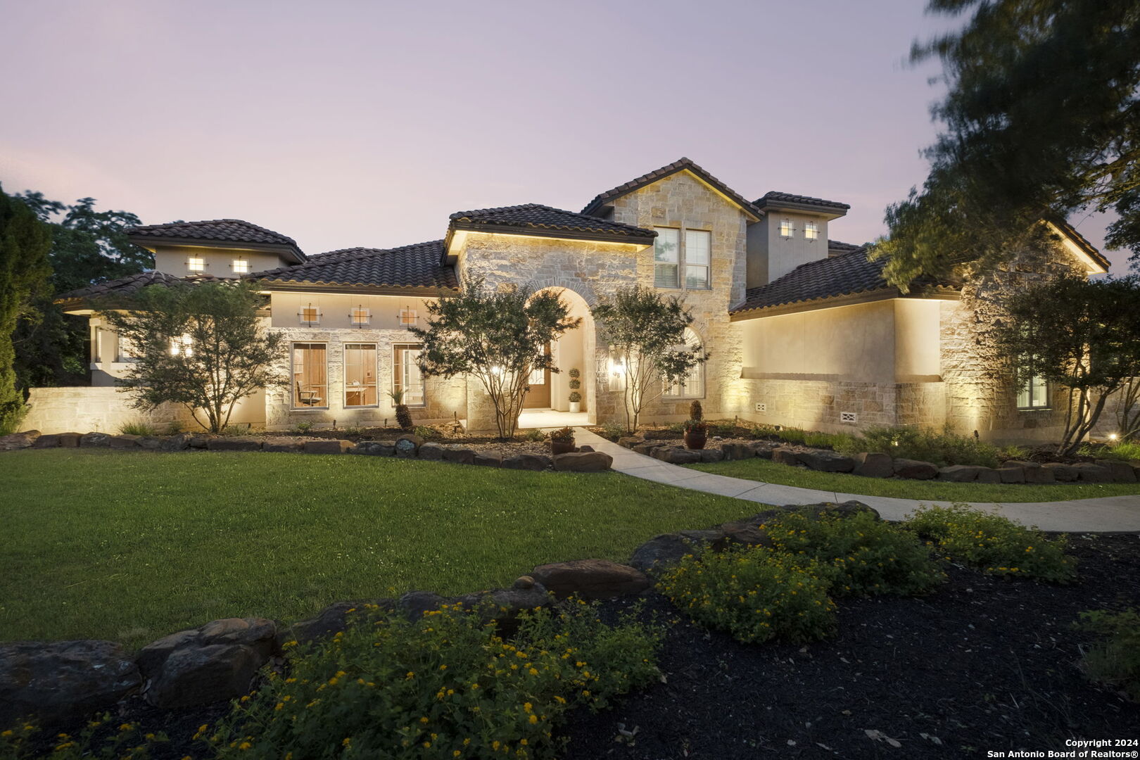 a front view of house with yard and green space