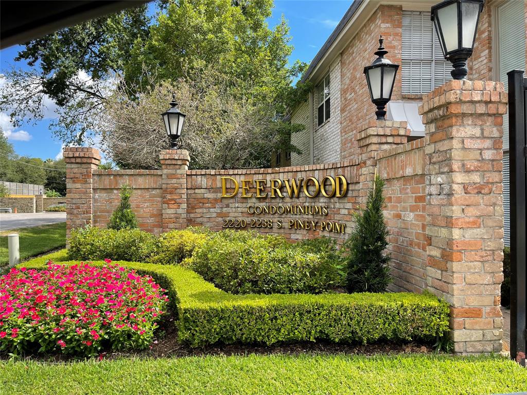 a view of sign board with yard and green space