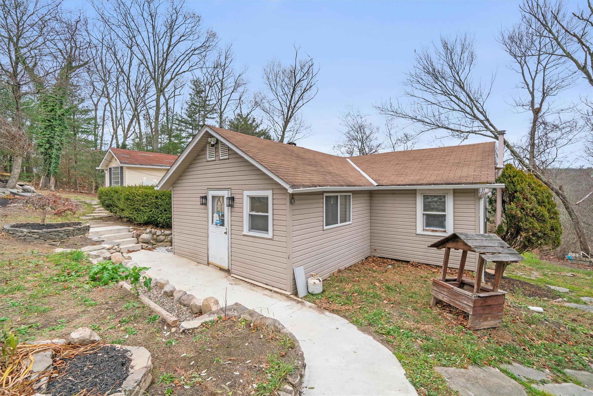 a view of a house with backyard and sitting area