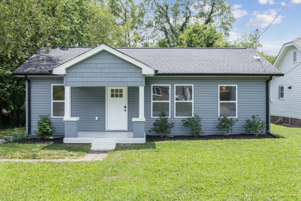 a front view of house with yard and green space