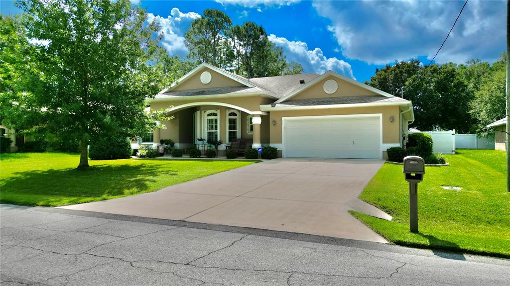 a front view of house with yard and green space