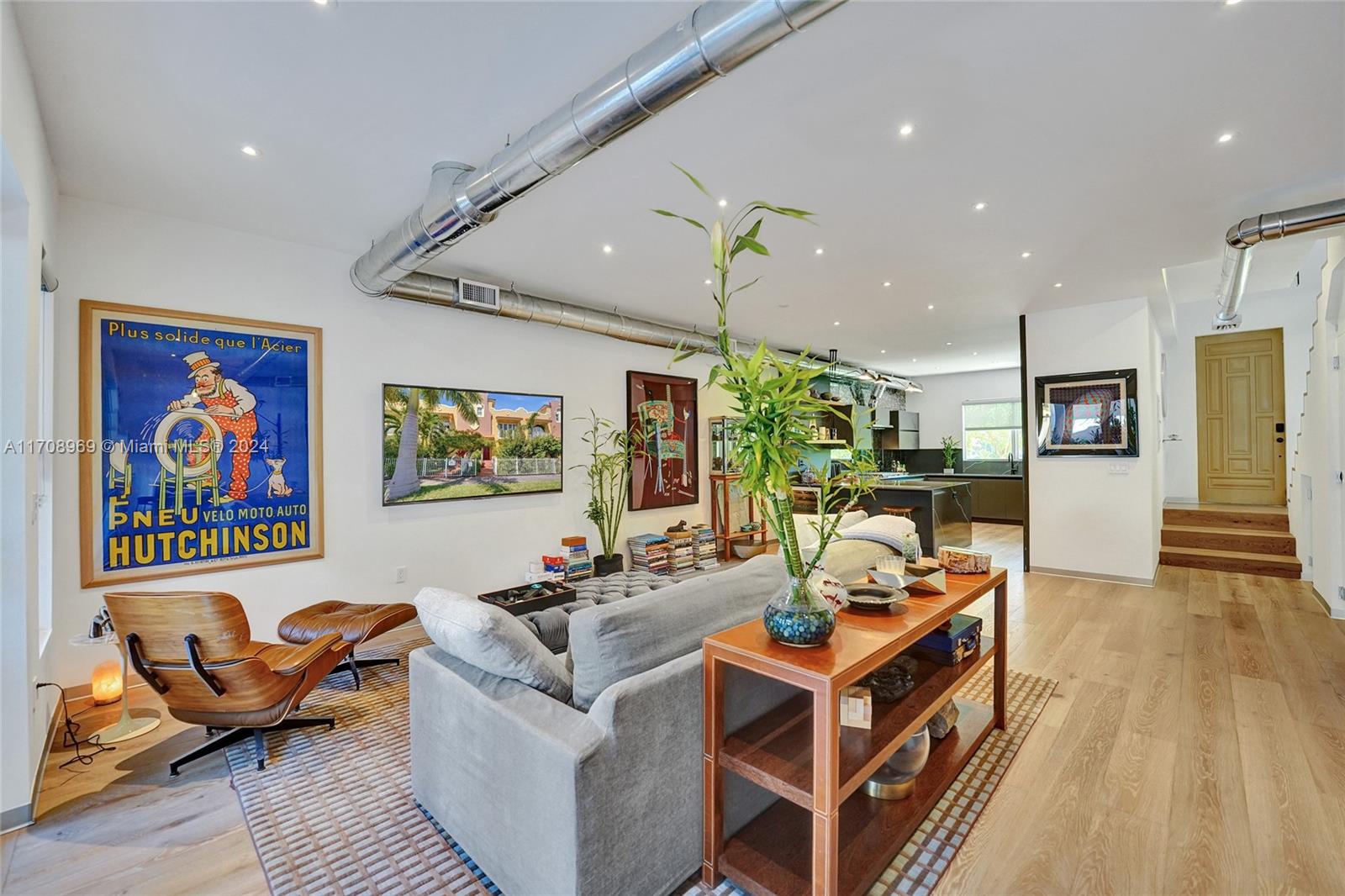 a living room with fireplace furniture and a wooden floor