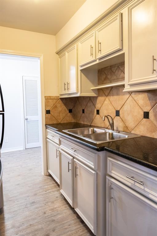 a kitchen with stainless steel appliances granite countertop a sink and a stove