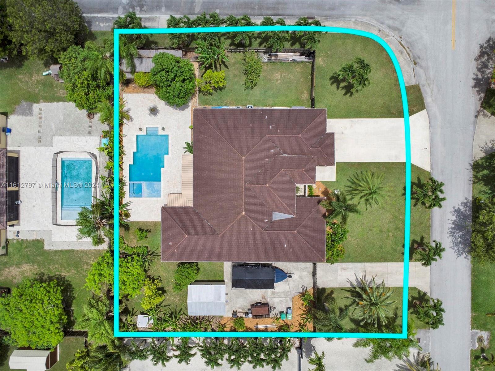 an aerial view of a house with a yard and plants