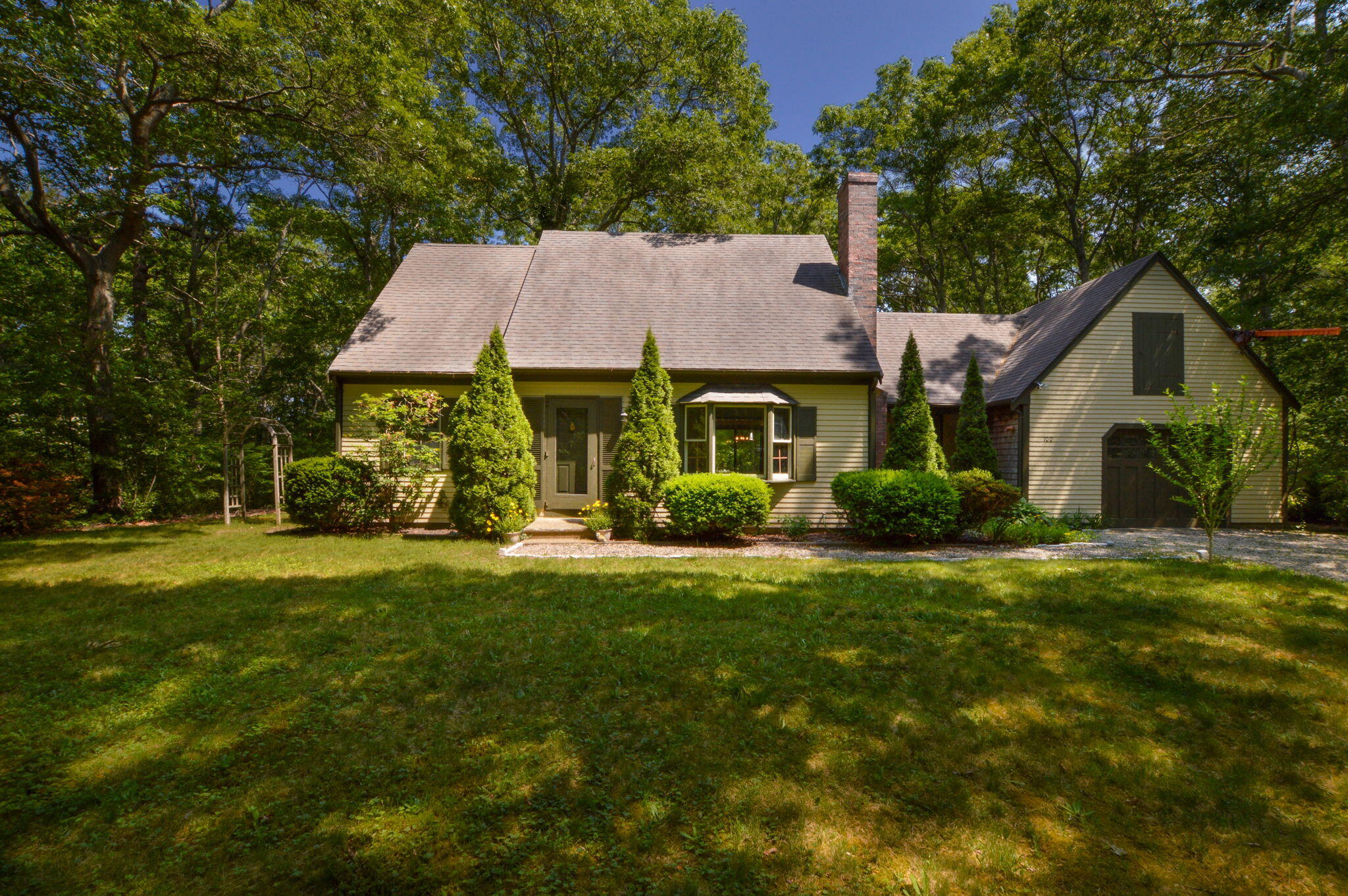 a front view of a house with a garden