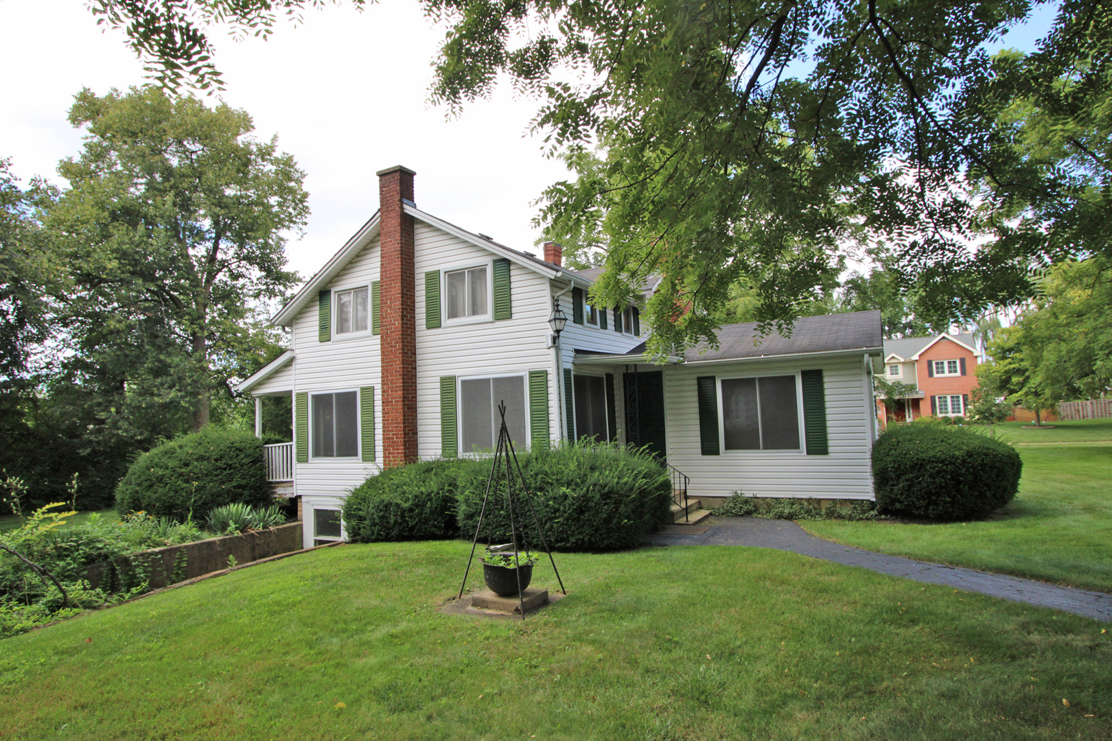 a house that has a tree in front of a house