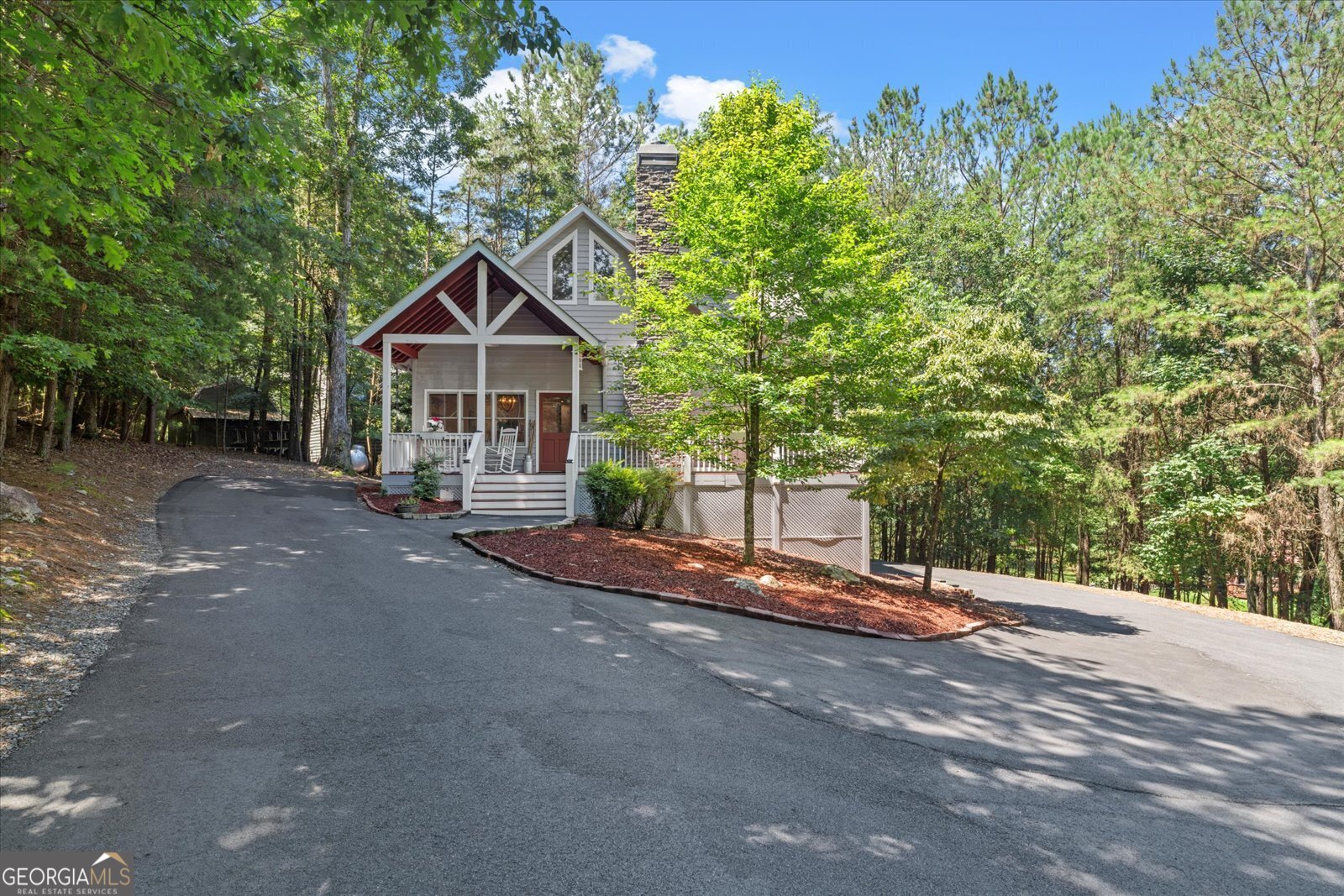 a view of a house with a tree and a yard