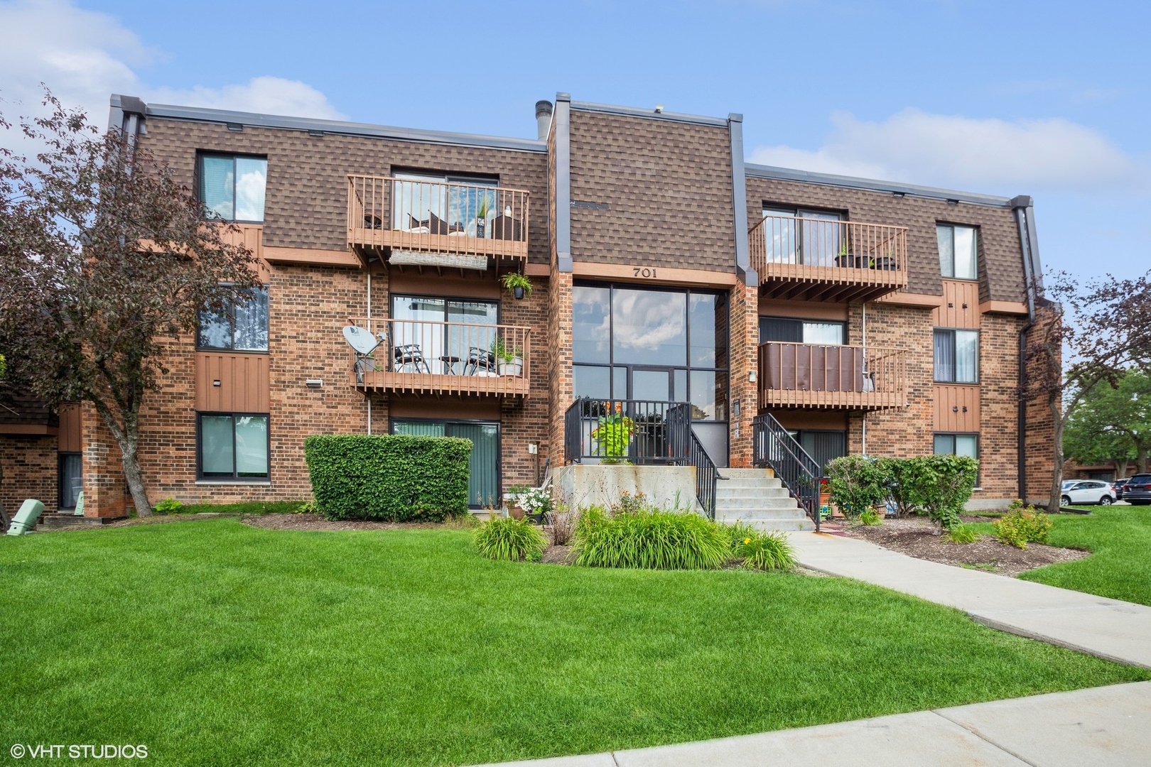 a front view of a house with a yard and outdoor seating