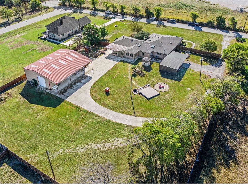 an aerial view of residential houses with outdoor space and swimming pool