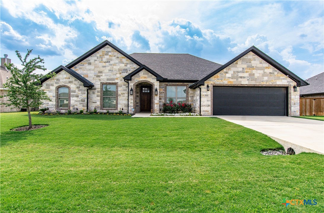 a front view of house with yard and green space